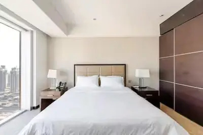 a bedroom with a large white bed and a window at Highest 1BR in JW Marriott Marina with Marina Views in Dubai