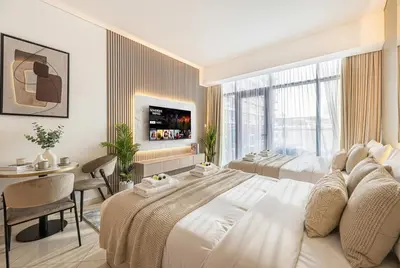 a hotel room with a large bed and a table at Seven Palm! Rooftop Infinity Pool with Great View! Private Beach Access! in Dubai