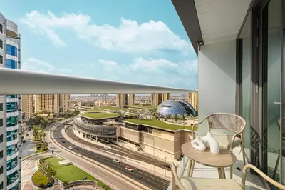 a balcony with a view of a city at Seven Palm! Rooftop Infinity Pool with Great View! Private Beach Access! in Dubai