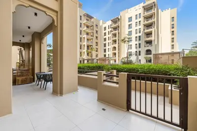 a balcony with a table and chairs and buildings at Modern 1BR in Jadeel 2 MJL in Low Floor in Dubai