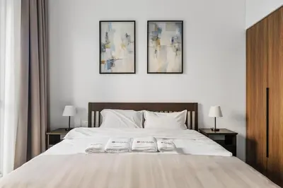 a bedroom with a bed with two towels on it at Modern 1BR in Jadeel 2 MJL in Low Floor in Dubai
