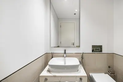 a bathroom with a sink and a mirror at Modern 1BR in Jadeel 2 MJL in Low Floor in Dubai