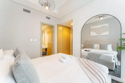 a bedroom with two beds and a large mirror at StayShort - Inviting 2BR in Business Bay with Wonderful Views in Dubai