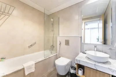 a bathroom with a sink and a toilet and a tub at StayShort - Inviting 2BR in Business Bay with Wonderful Views in Dubai