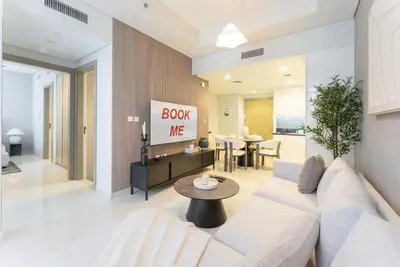a living room with a white couch and a table at StayShort - Inviting 2BR in Business Bay with Wonderful Views in Dubai