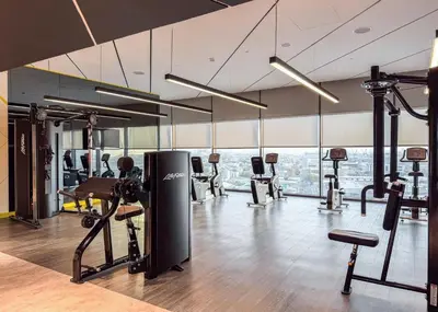 a gym with several treadmills and exercise machines at StayShort - Inviting 2BR in Business Bay with Wonderful Views in Dubai