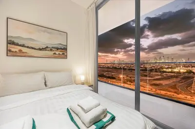 a bedroom with a bed and a large window at FiveX Binghatti 2BR with Private Pool in Dubai