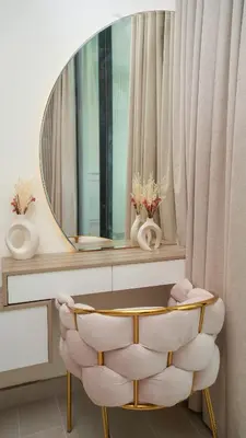 a dressing room with a chair and a mirror at NEW Studio in JVC with Pool View in Dubai