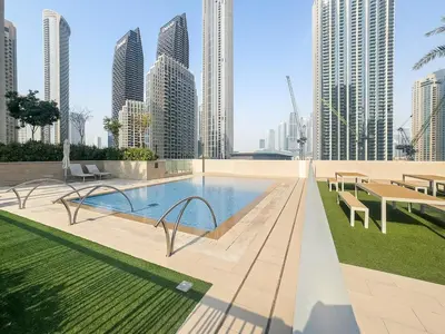 a pool in the middle of a city with tall buildings at FIRST CLASS 2BR Stylish Downtown Living in Dubai