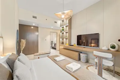 a living room with a couch and a tv at FIRST CLASS 2BR Stylish Downtown Living in Dubai