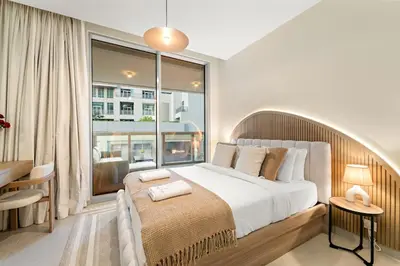 a bedroom with a large bed and a large window at FIRST CLASS 2BR Stylish Downtown Living in Dubai