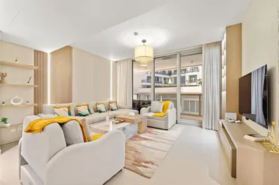 a living room with white furniture and a large window at FIRST CLASS 2BR Stylish Downtown Living in Dubai
