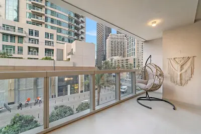 a room with a chair and a large window at FIRST CLASS 2BR Stylish Downtown Living in Dubai