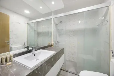 a bathroom with a sink and a shower at FiveX Premium 2BR with Extra Room in Dubai
