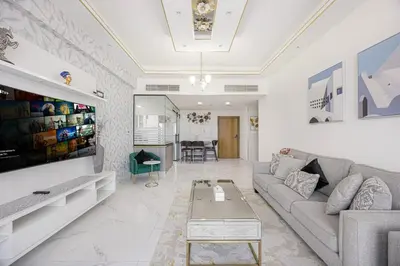 a living room with a couch and a table at FiveX Premium 2BR with Extra Room in Dubai