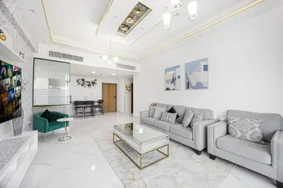 a living room with a couch and a table at FiveX Premium 2BR with Extra Room in Dubai