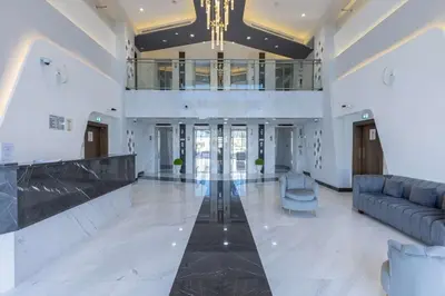 a large lobby with a couch and a chandelier at FiveX Premium 2BR with Extra Room in Dubai