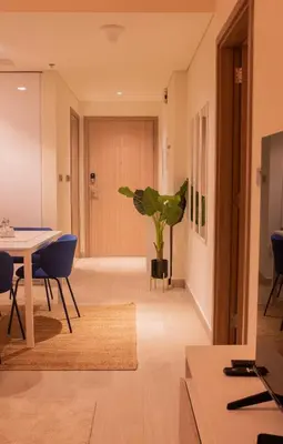a living room with a table and a potted plant at Spacious Comfortable One Bed Downtown Dubai in Dubai