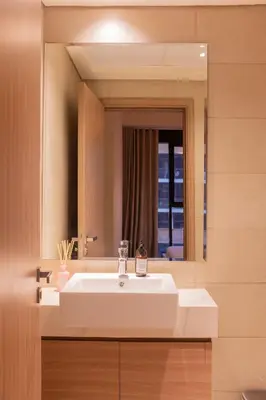 a bathroom with a white sink and a mirror at Spacious Comfortable One Bed Downtown Dubai in Dubai