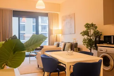 a living room with a table and chairs at Spacious Comfortable One Bed Downtown Dubai in Dubai