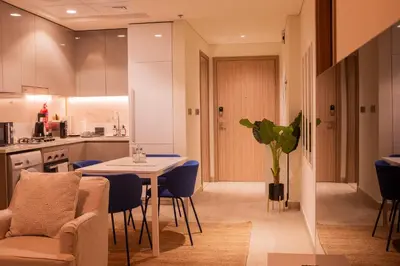 a kitchen and living room with a table and chairs at Spacious Comfortable One Bed Downtown Dubai in Dubai