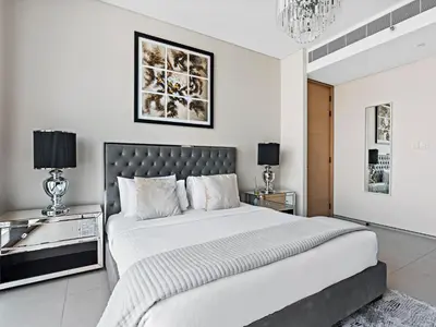 a bedroom with a large bed and two night stands at Timeless Elegance 1BR Address Beach JBR in Dubai