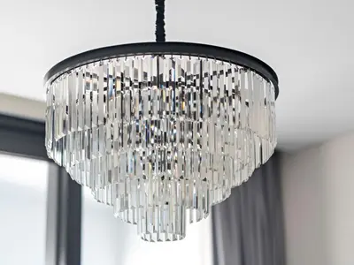 a large glass chandelier hanging from a ceiling at Timeless Elegance 1BR Address Beach JBR in Dubai