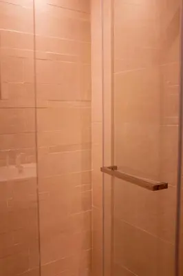 a bathroom with a shower with a glass door at Snug Modern Downtown Dubai Studio in Dubai