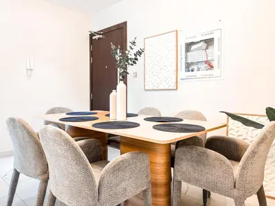 a dining room with a wooden table and chairs at Jewelz by Danube, Arjan, Al Barsha - Onelink in Dubai