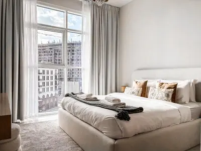a bedroom with a bed with a large window at Jewelz by Danube, Arjan, Al Barsha - Onelink in Dubai