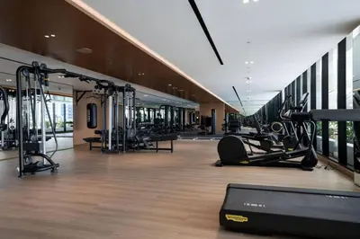 a gym with treadmills and cardio equipment in a building at Modern Studio with Private Jacuzzi in Dubai