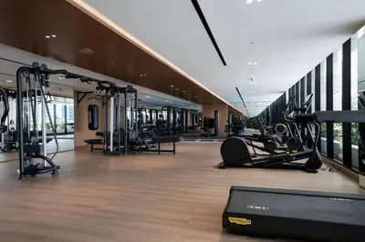 a gym with treadmills and cardio equipment in a building at Modern Studio with Private Jacuzzi in Dubai