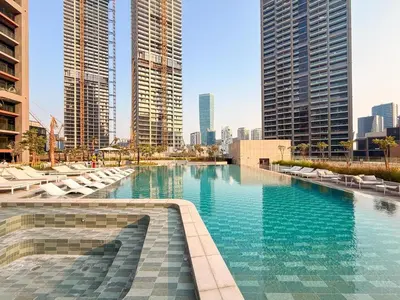a swimming pool in a city with tall buildings at GuestReady - 1BR Luxury | Prime City Area in Dubai
