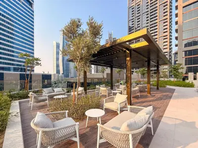 a pavilion with chairs and tables in a city at GuestReady - 1BR Luxury | Prime City Area in Dubai