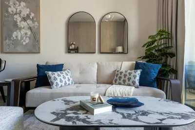 a living room with a couch and a table at GuestReady - 1BR Luxury | Prime City Area in Dubai
