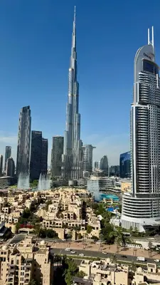 a view of a city with skyscrapers and buildings at Rentico l Ultra Luxury 2BR Burj Khalifa & Fountain in Dubai