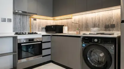a kitchen with a washer and a washing machine at Jumeirah Village Triangle in Dubai