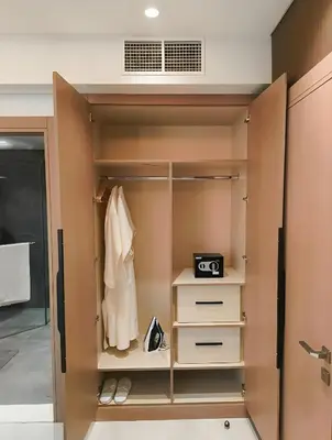 a walk in closet with a robe and shoes at Jumeirah Village Triangle in Dubai