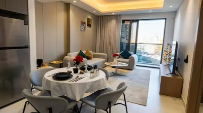 a room with a table and chairs and a living room at Jumeirah Village Triangle in Dubai