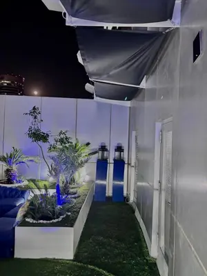 a night view of a building with plants and lights at Full marina view private pool vip adult only no halal in Dubai