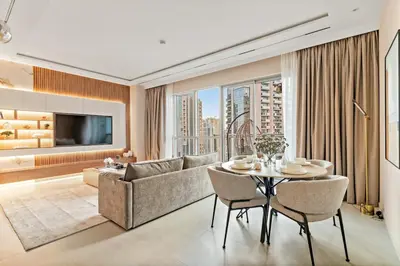 a living room with a couch and a table at FIRST CLASS 1BR Elegance Near Burj Khalifa in Dubai