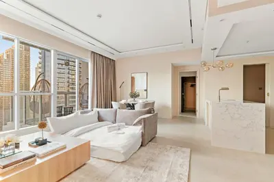 a living room with a couch and a table at FIRST CLASS 1BR Elegance Near Burj Khalifa in Dubai