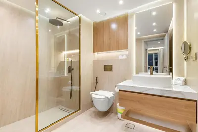 a bathroom with a toilet and a shower and a sink at FIRST CLASS 1BR Elegance Near Burj Khalifa in Dubai