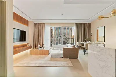 a living room with a bed and a dining room at FIRST CLASS 1BR Elegance Near Burj Khalifa in Dubai