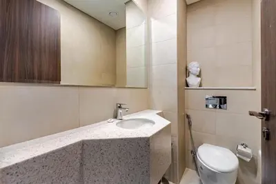 a bathroom with a sink and a toilet at Prestige Avani Residence 2BR with Golf Course View in Dubai