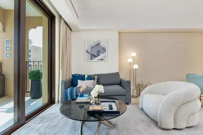 a living room with a couch and a chair and a table at Brand New Luxury Family Friendly 3 beds Near Burj AlArab Ultimate Stay in Dubai