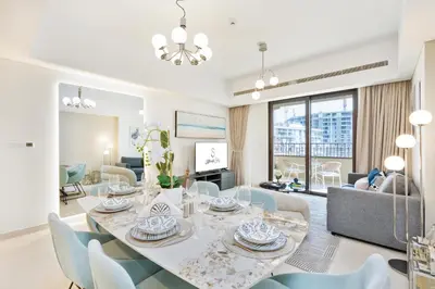 a dining room and living room with a table and chairs at Brand New Luxury Family Friendly 3 beds Near Burj AlArab Ultimate Stay in Dubai