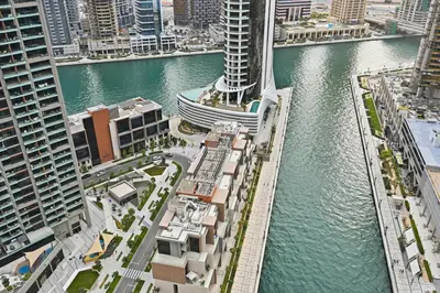 an aerial view of a city with a river and buildings at Curated High Floor 1BR-Sofa Bed Water View Peninsula 1 in Dubai