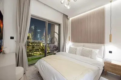 a bedroom with a bed and a large window at Burj Khalifa & Downtown Skyline View Apartment in Dubai