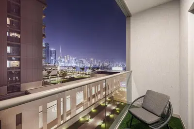a balcony with a chair and a view of a city at Burj Khalifa & Downtown Skyline View Apartment in Dubai